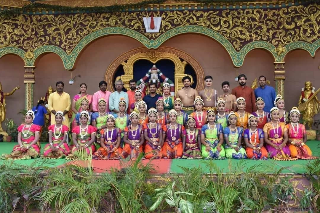 Large classical dance ensemble on an ornate golden stage — Uddharsha Foundation cultural programme