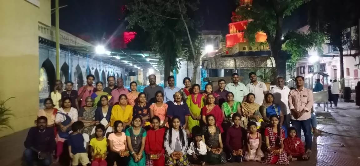 Community gathering at an illuminated temple courtyard in the evening — Uddharsha Foundation cultural gathering