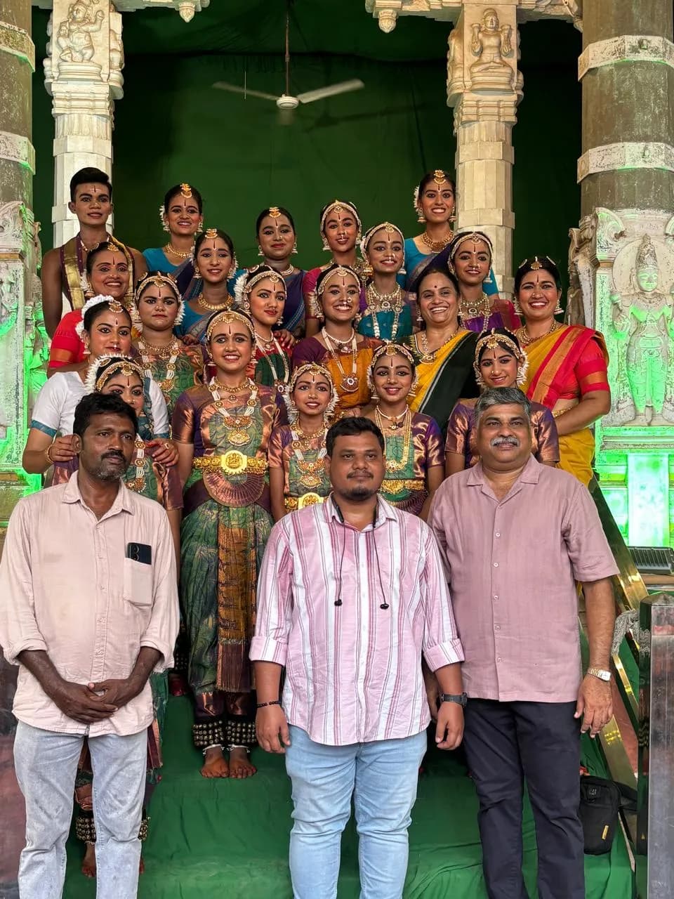 Dance ensemble with their mentors on the steps of a heritage temple pavilion — Uddharsha Foundation cultural event