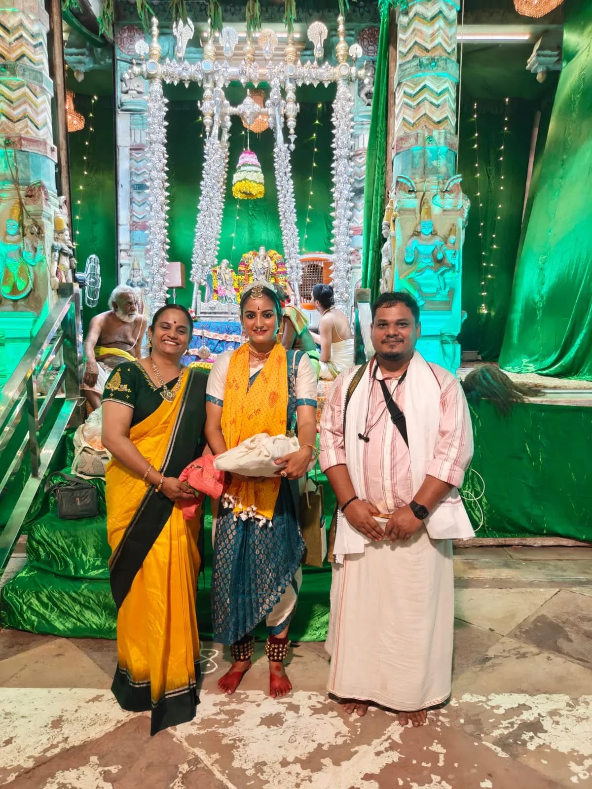 A dancer honoured with her mentors at a temple sanctum after a devotional performance — Uddharsha Foundation